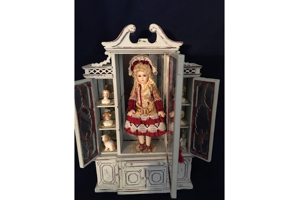 doll and heads in cabinet